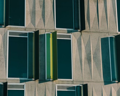 Sunlight filtering through modern architectural louvers in a workspace environment